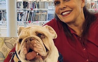 Sharon Foltz Community Service Recognition Sharon smiling while hugging bulldog Winston